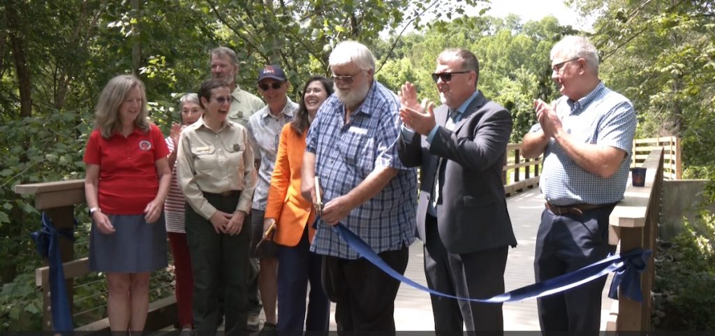 State and local officials attend a ribbon-cutting ceremony marking the completion of the 88-mile Baileys Trail System in southeast Ohio.