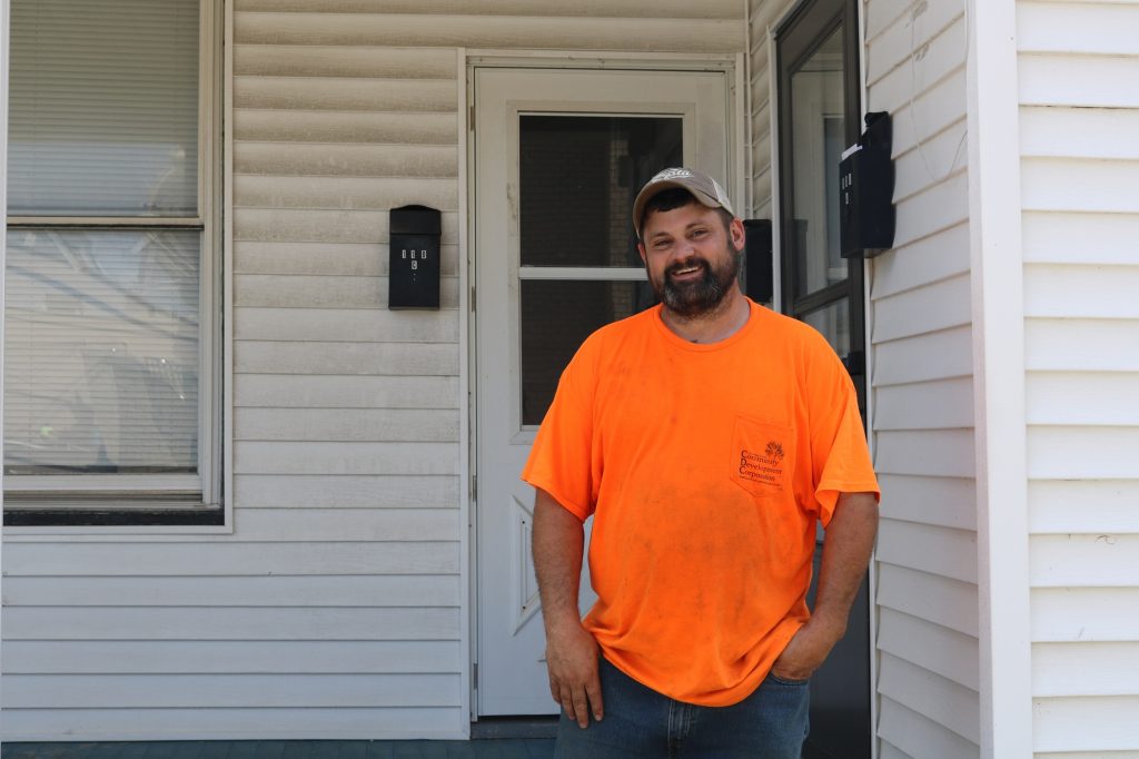 Guernsey County resident Chris Gilwreath stands in front of the entrance to his apartment.