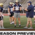 The Lancaster head coach talks to his players during a team summer practice.