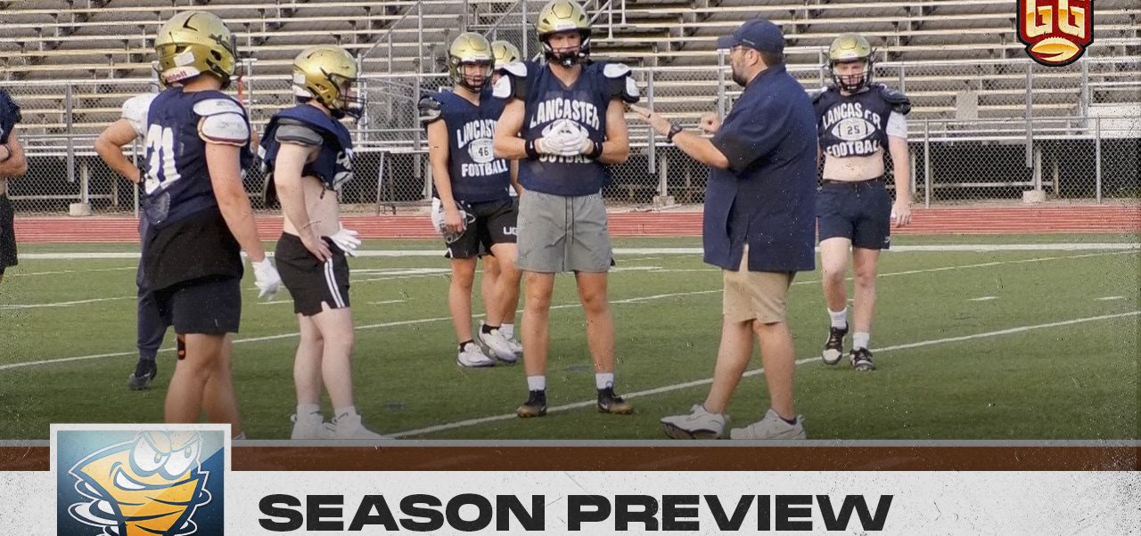 The Lancaster head coach talks to his players during a team summer practice.