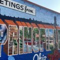 A mural on the side of a building reads "Greetings from Springfield, Ohio"