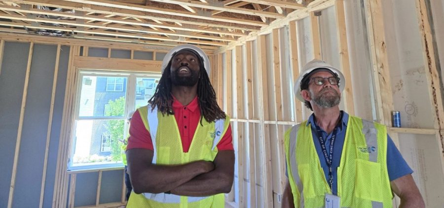 Cincinnati code inspectors Obadare Ajao and Gino Battistella look over construction progress at a townhouse development.
