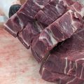 Chase Meeks organizes cuts of beef for a customer's order.