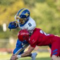 West Muskingum wide receiver tries to break a tackle by a Fort Frye defender.