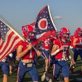Licking Valley runs out with flags before their week one matchup against Sheridan.