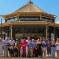 Governor Mike DeWine and his wife, Fran, center, cut a ribbon to open the new carousel at the Ohio State Fairgrounds