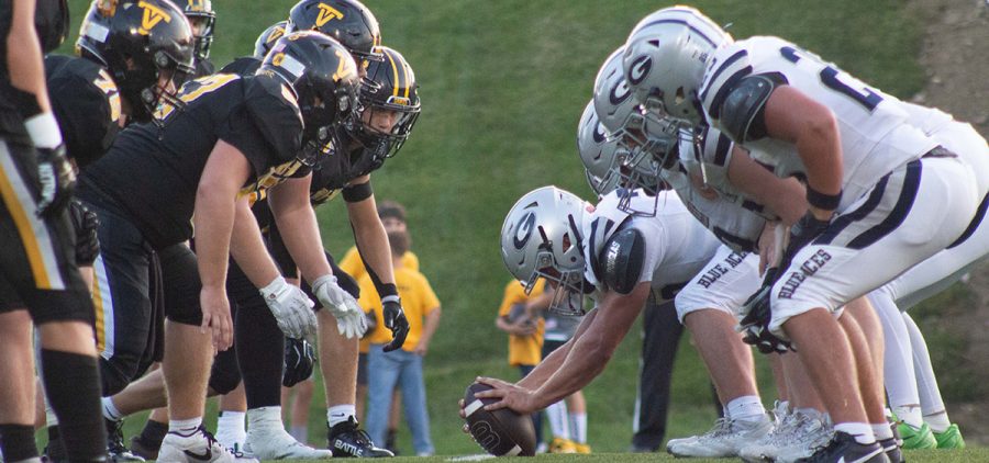Tri-Valley Scotties and Granville Blue Aces line up on the field getting ready to hike the ball.