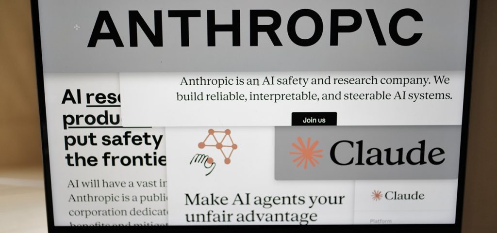 Pages from the Anthropic website and the company's logos are displayed on a computer screen