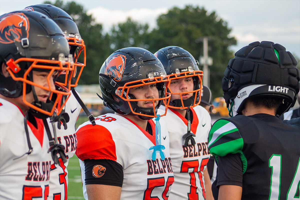 The Belpre Golden Eagles and Green Bobcats are meeting up for the coin toss before the game starts.