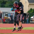 Two Crooksville Ceramic players are celebrating in the end zone after a touchdown.