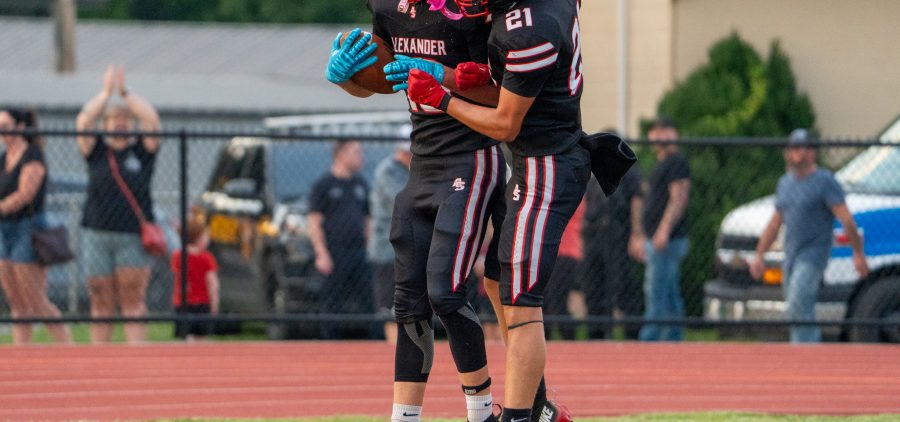 Two Crooksville Ceramic players are celebrating in the end zone after a touchdown.