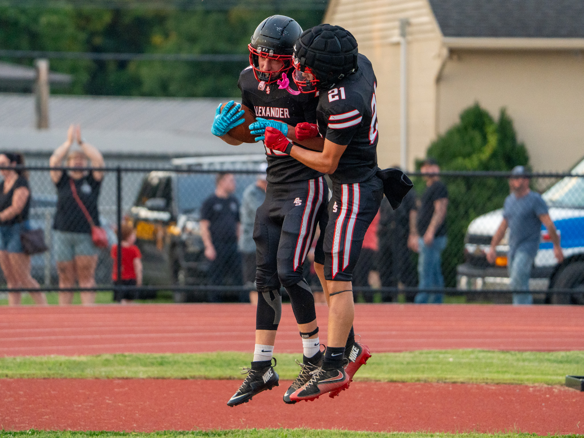 Two Crooksville Ceramic players are celebrating in the end zone after a touchdown.