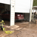 Mud and other debris from a flood cake the garage floor and driveway at a home in Pomeroy.