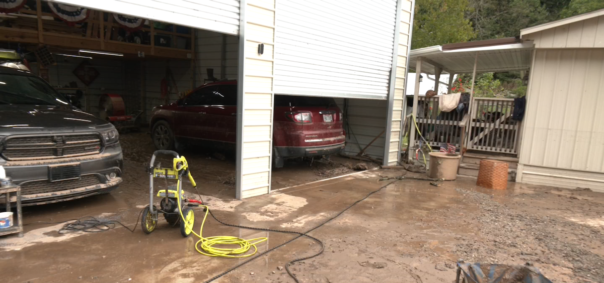 Mud and other debris from a flood cake the garage floor and driveway at a home in Pomeroy.