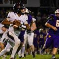 The Circleville quarterback rolls out the pocket, looking downfield for a teammate to pass to, while having McClain defenders on his tail.