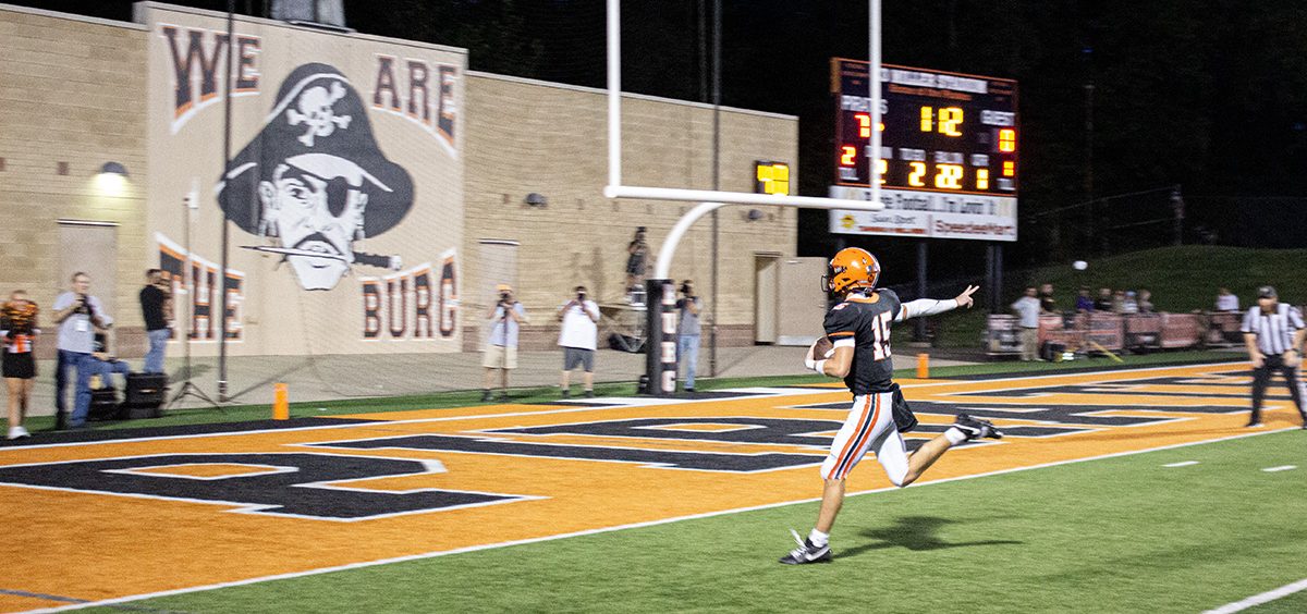 A Wheelersburg player throws up the peace sign as he crosses the goal line for a Pirates touchdown.