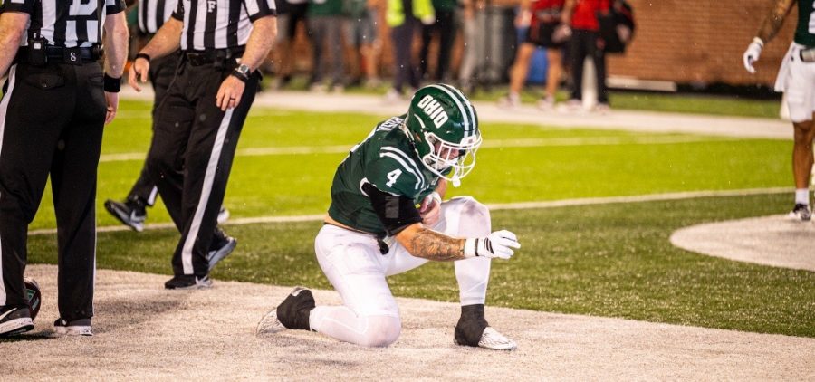 Victor Rosa kneeling after a game tying touchdown