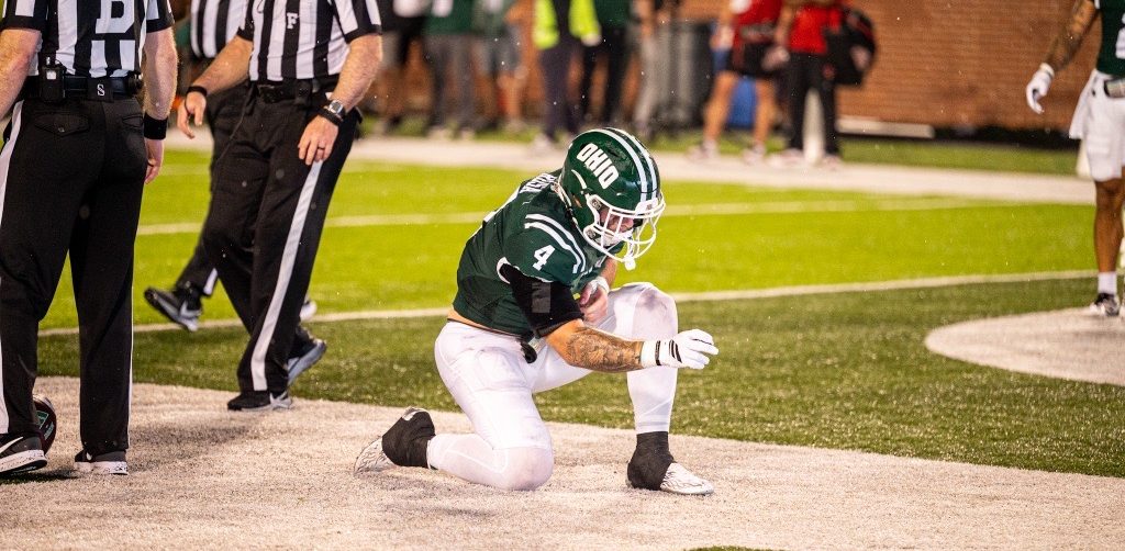 Victor Rosa kneeling after a game tying touchdown
