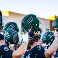Ohio Football players lifting their helmets in celebration in win against Stonehill