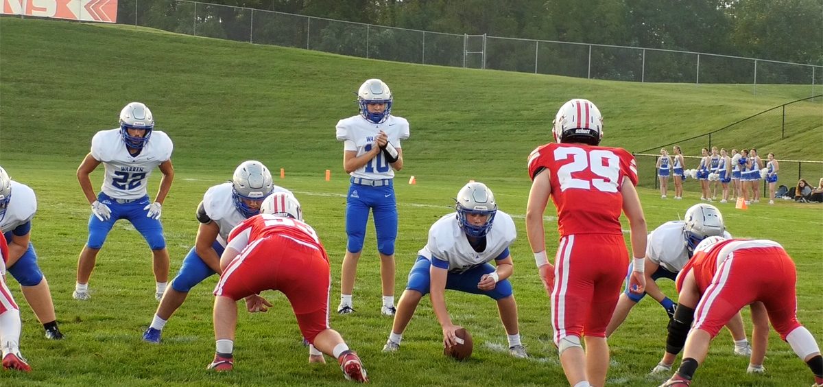 The Warren QB claps his hands to start the play against the Hillsboro Indians.