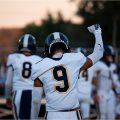 A South Point player is raising his fist in the air with his head down.