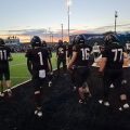 Tri-Valley players are walking out on the end zone.
