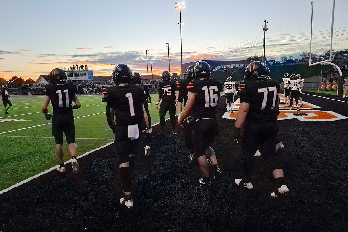 Tri-Valley players are walking out on the end zone.