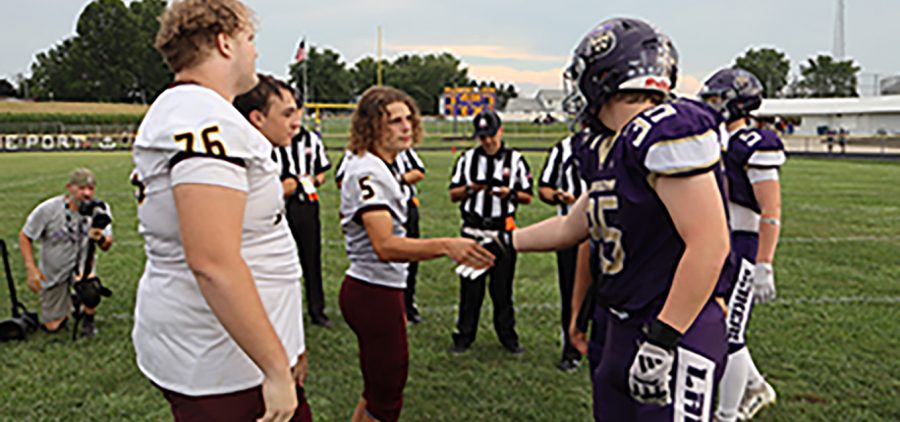 Federal Hocking and Millersport are meeting for the coin toss in center field before the game.