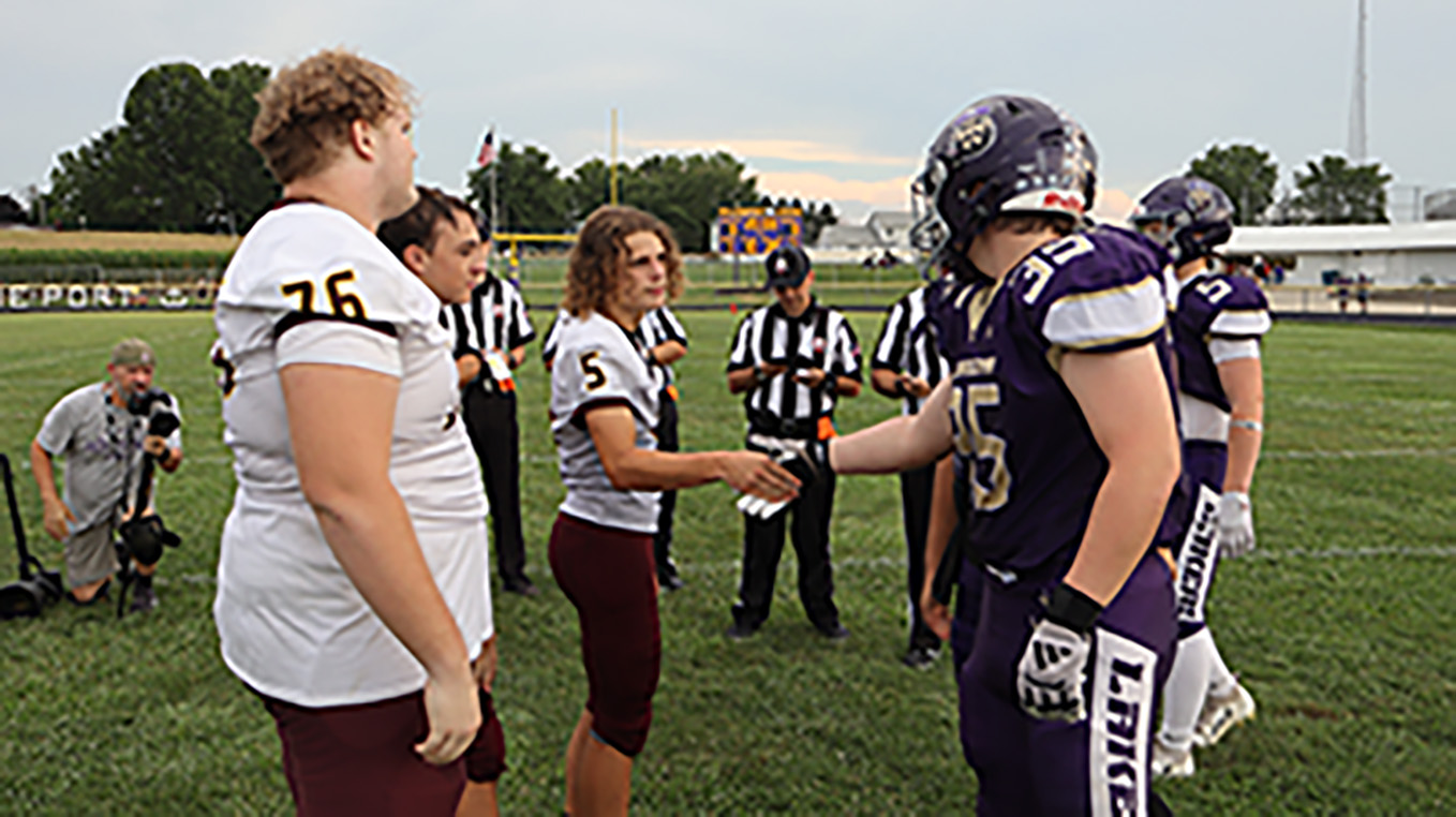 Federal Hocking and Millersport are meeting for the coin toss in center field before the game.