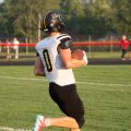 Julian Baker with the football running into the endzone to score a touchdown.