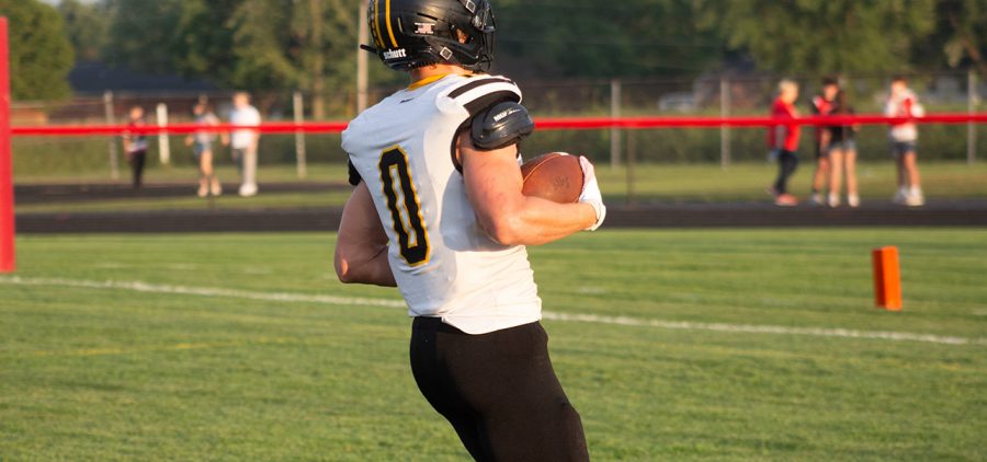 Julian Baker with the football running into the endzone to score a touchdown.