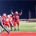 A group of Jackson Ironmen are celebrating near the end zone.