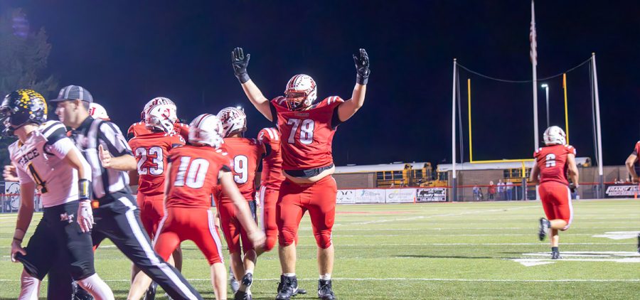 A group of Jackson Ironmen are celebrating near the end zone.