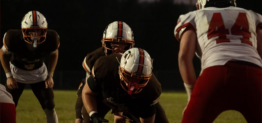 Minford and Eastern line up at the ball to snap it and run a play.