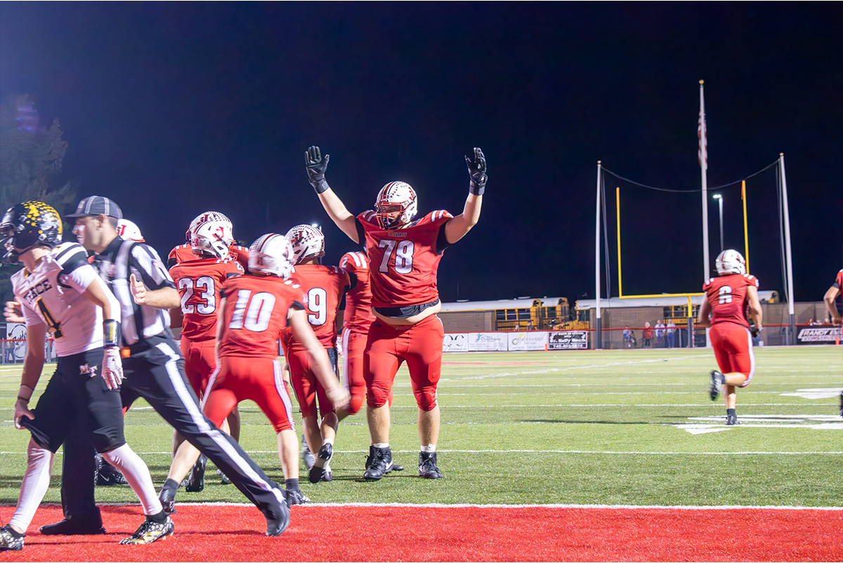 A group of Jackson Ironmen are celebrating near the end zone.