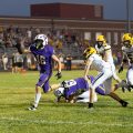 McClain player is running past Paint Valley players to try and reach the end zone.