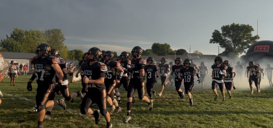 The Amanda-Clearcreek Aces are running out of the tunnel to prepare for the game.