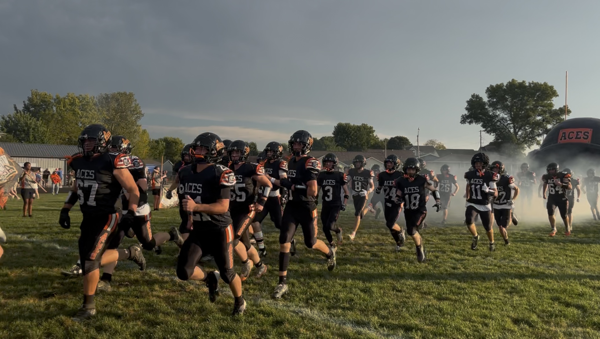 The Amanda-Clearcreek Aces are running out of the tunnel to prepare for the game.
