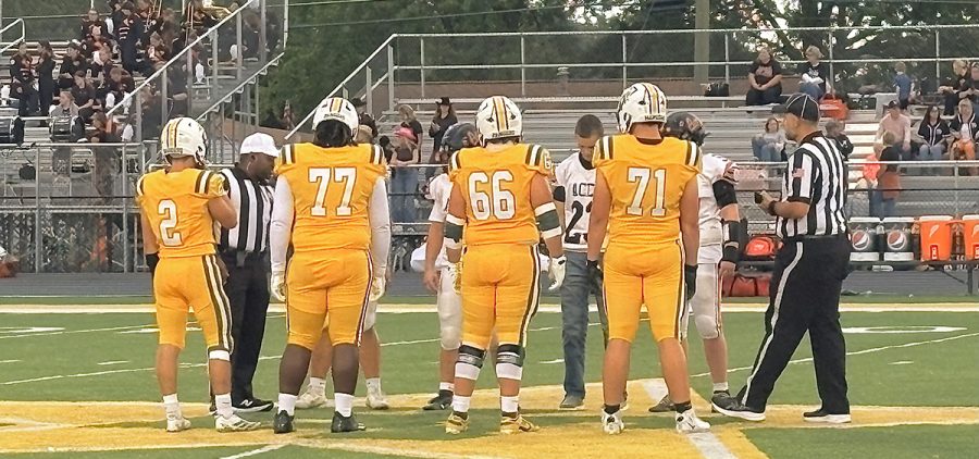 The Hamilton Township Rangers and the Amanda-Clearcreek players meet at midfield for the coin toss.