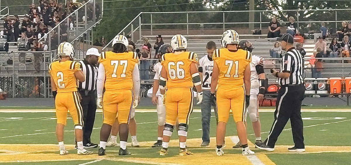 The Hamilton Township Rangers and the Amanda-Clearcreek players meet at midfield for the coin toss.