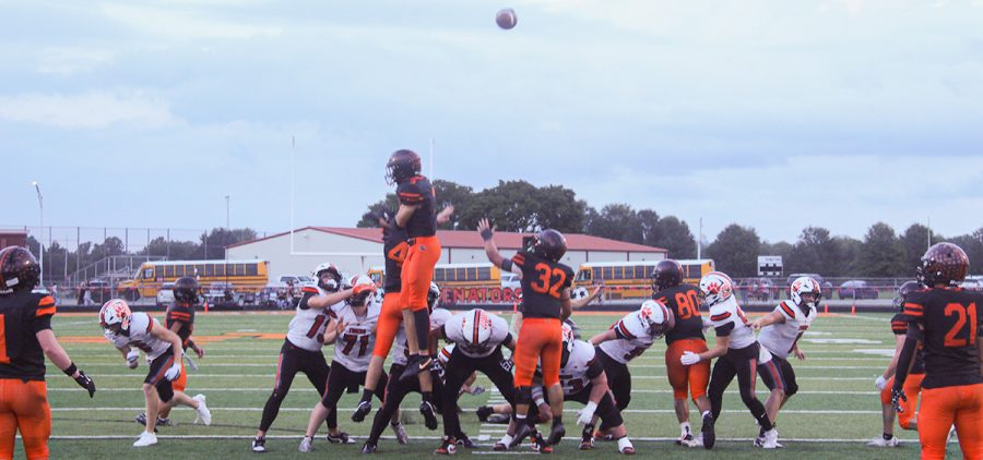 The Tigers try for a point after try, with the Senators trying to block the kick.