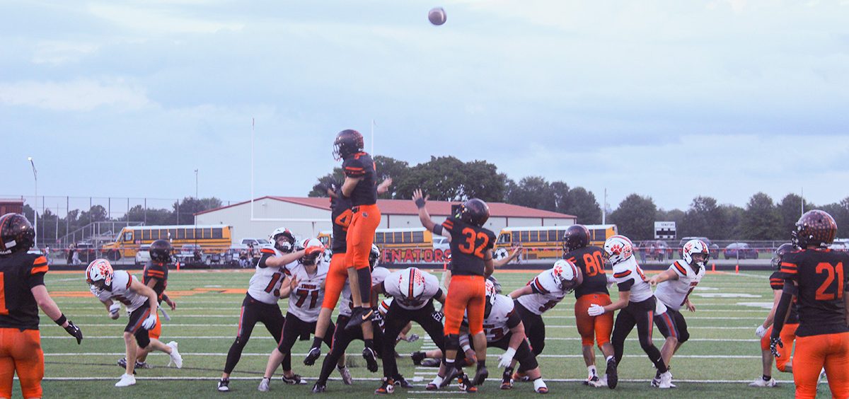 The Tigers try for a point after try, with the Senators trying to block the kick.