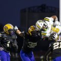 Hamilton Township running back hurdles a group of Bloom-Carroll defenders.