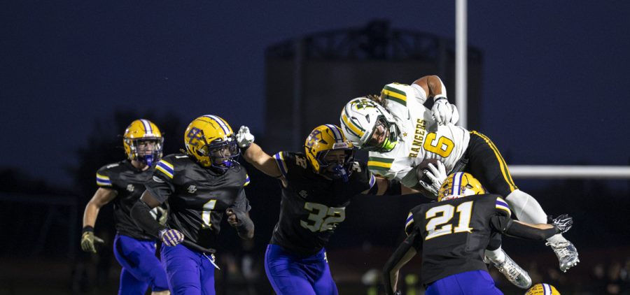 Hamilton Township running back hurdles a group of Bloom-Carroll defenders.