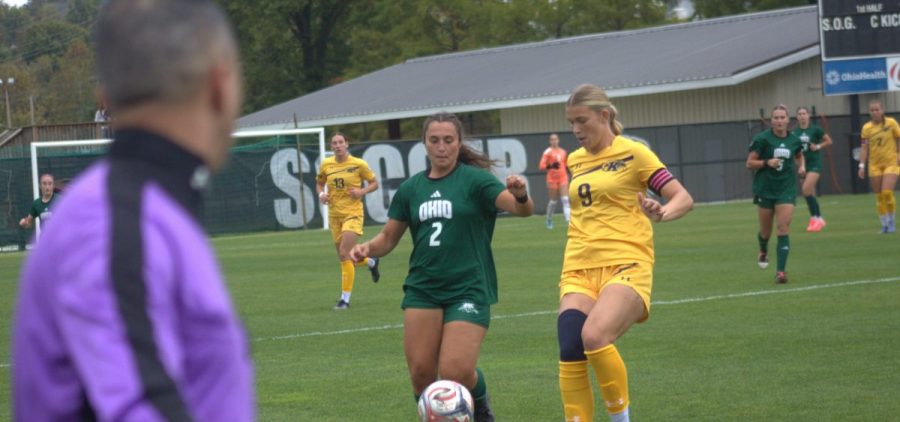 Ohio Soccer player dribbles past Kent State challenger in Ohio loss to Kent State