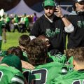 The Huntington Huntsmen huddle around coach after a win against Paint Valley to secure a share of the Scioto Valley Conference title.