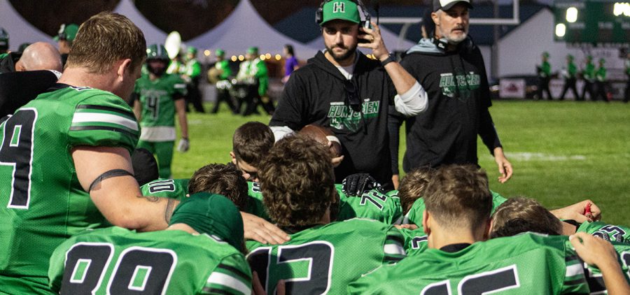 The Huntington Huntsmen huddle around coach after a win against Paint Valley to secure a share of the Scioto Valley Conference title.