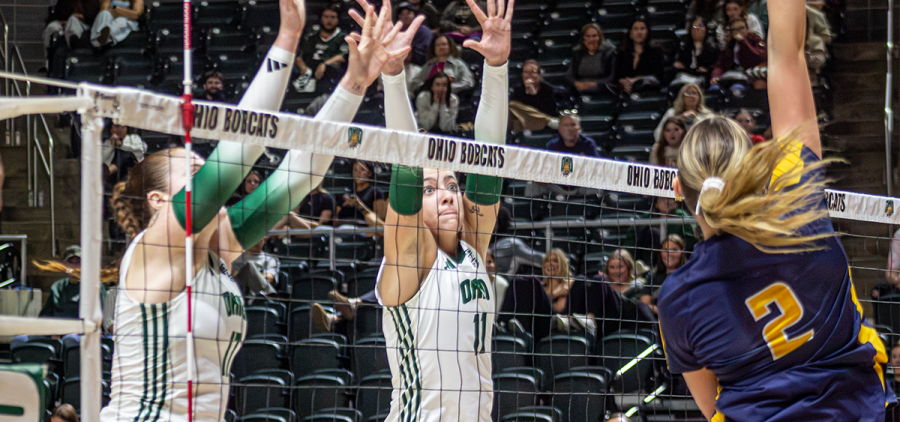 Ohio Volleyball middle blocker, Emily Waddell and opposite hitter Bailey Blair blocking a spike in win against Kent State