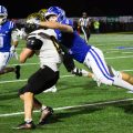 A Chillicothe player is trying to tackle and Miami Trace player.