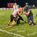 Wellston players are trying to take down Nelsonville-York athlete as he runs the ball.